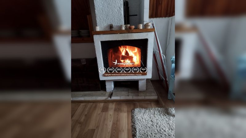 There is a fireplace in the family house on a floor with a wood decor.