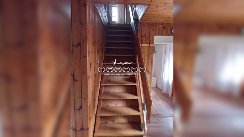 Wooden stairs lead to the upper floor in a family house with a wooden decor floor.