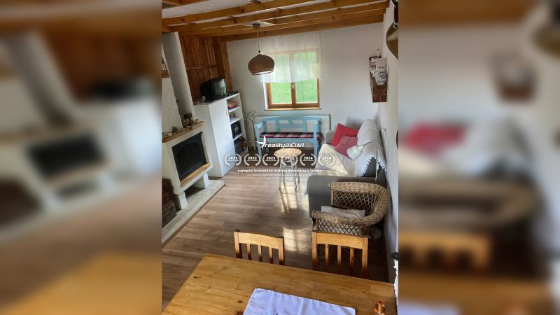 Living room in a family house with a fireplace, an armchair, and a wooden decor floor.