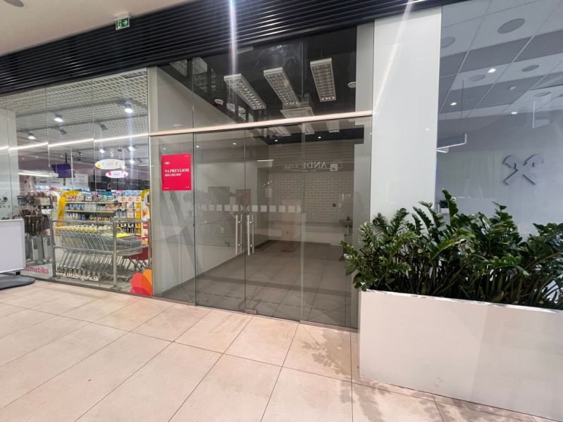 Glass facade of a retail space in a shopping center with a renovation notice.