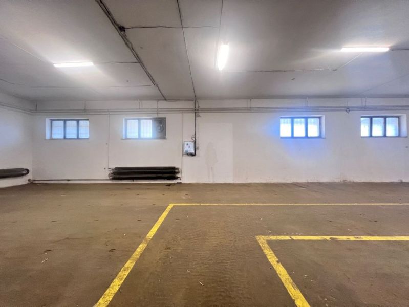 An empty hall with windows and floor markings. Warehouses and halls.