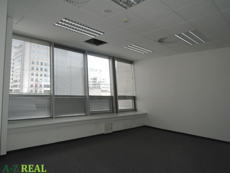 Offices with blinds and carpet, ceiling with lighting and ventilation.