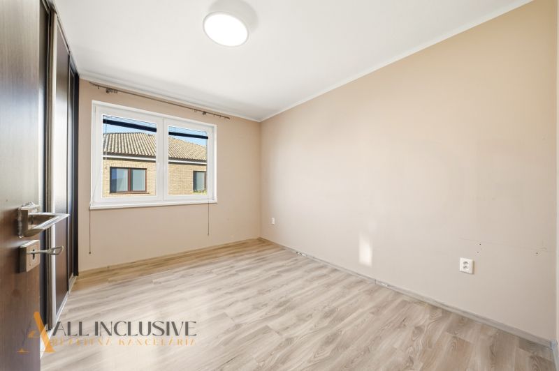 A bright room in a 3-room apartment with a wood-patterned floor and white walls.