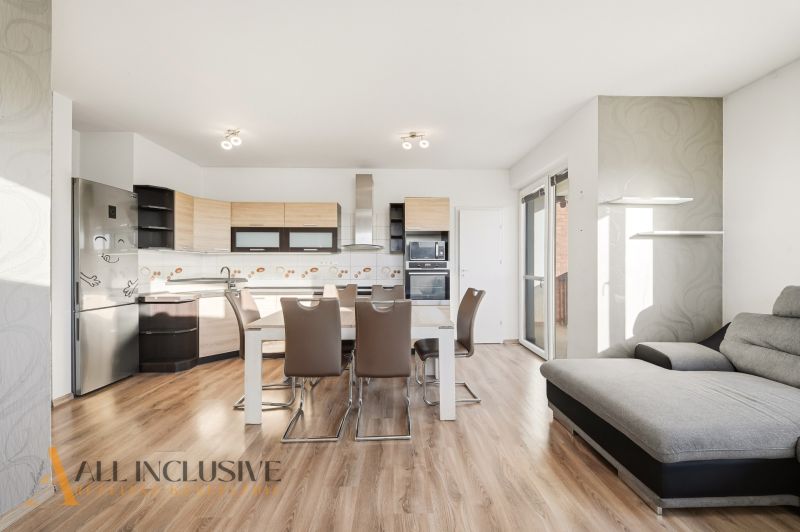 A kitchen with a dining table in a 3-room apartment, floor with wood decor.