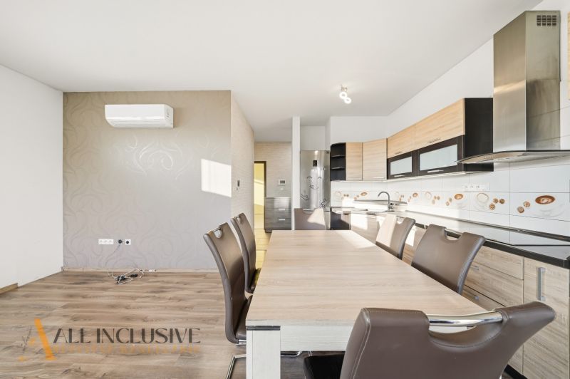 A kitchen with a dining table in a 3-room apartment, floor with wood decor.