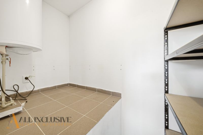 Storage space in a 3-room apartment with a boiler and a shelf for storage.