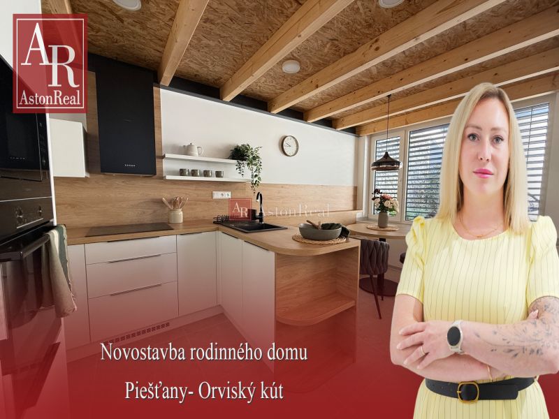 A kitchen in a family house with a wooden decor floor, wooden beams, and a dining table.