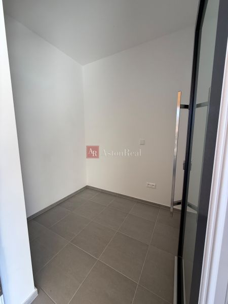 A small room in a family house with white walls and tiles.