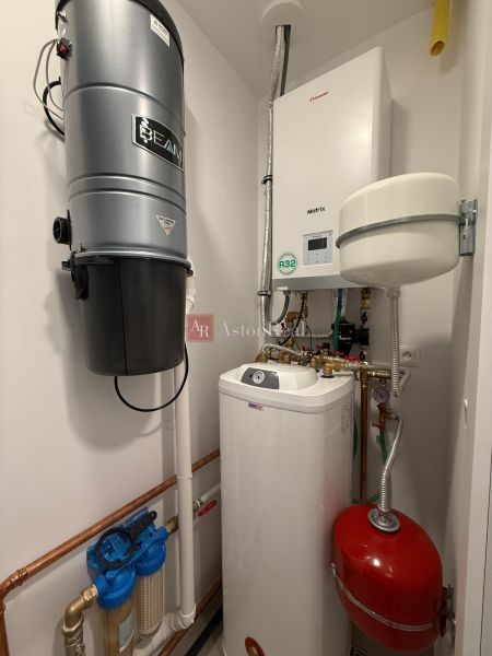 Boiler room in a family house with a boiler and a central vacuum system.