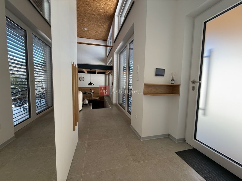 Entrance hall in a family house with large windows and skylights.