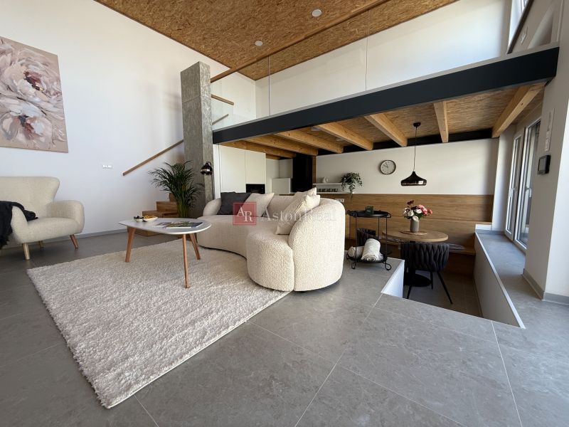 Living room in a family house with comfortable furniture and wall decorations.