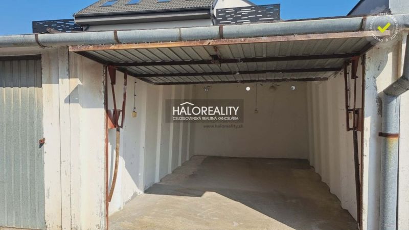 An empty garage in Senec with a roof and white walls.