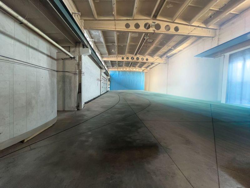 Production premises with a concrete floor and light walls, reinforced ceiling.