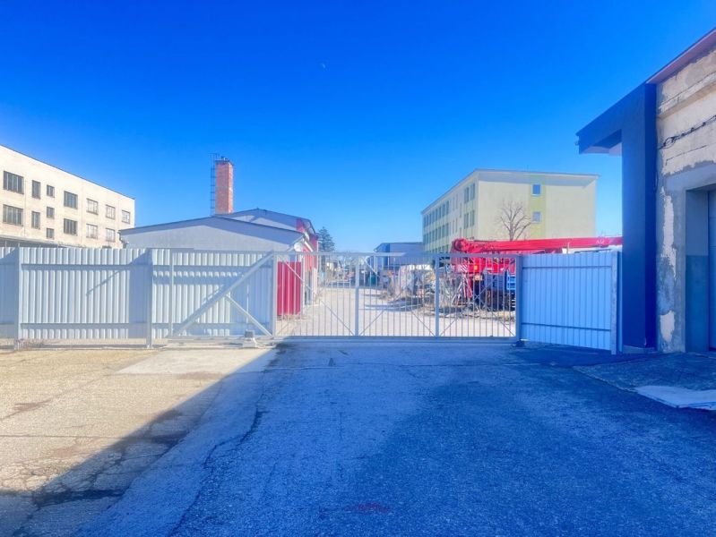 Production facilities on Majerská cesta in Banská Bystrica with a gate and industrial buildings.