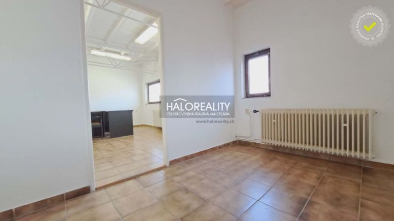 Offices with tiled floors, radiator, and natural light.