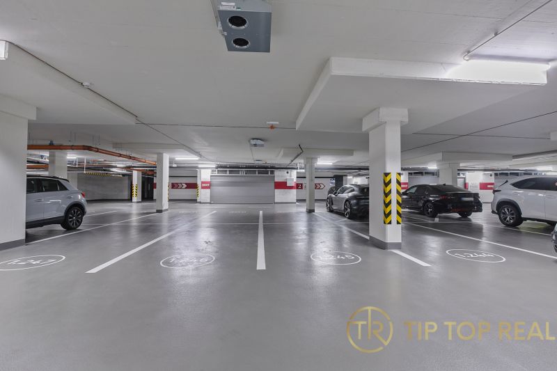 Underground parking on Továrenská Street, spacious underground parking near a 3-room apartment.