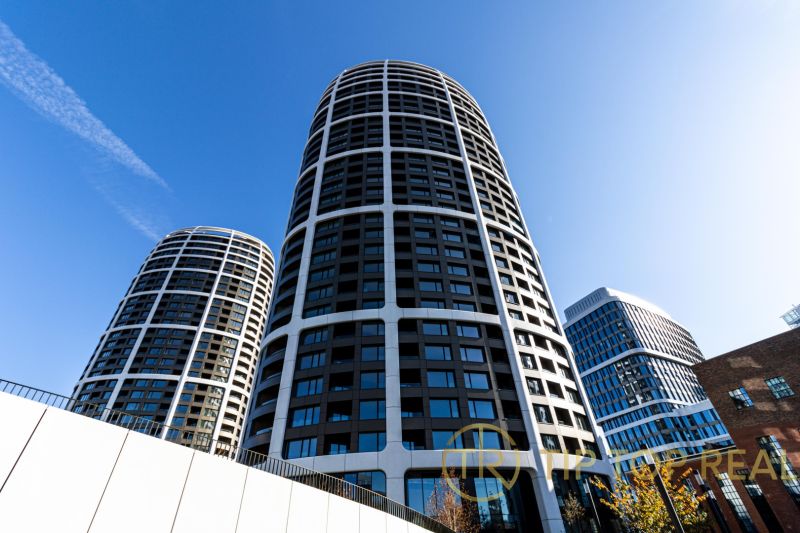 The high-rise building on Továrenská Street, suitable for a 3-room apartment, dominates the city skyline.