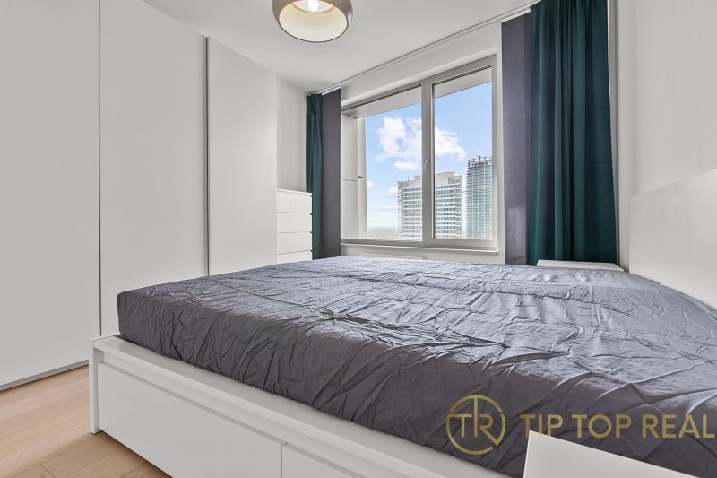 Bedroom in a 3-room apartment with wooden flooring, view on Továrenská street.