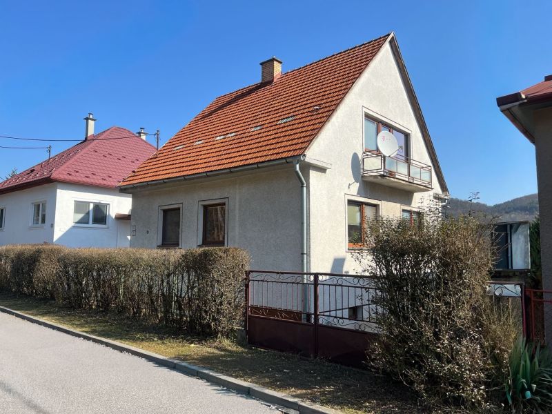 A family house in the village of Podháj, Kráľová, Banská Bystrica with a red roof and a garden.