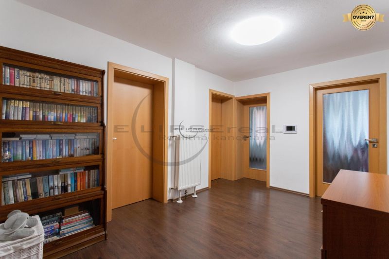 Interior of a family house with wooden floor decoration and a bookshelf.
