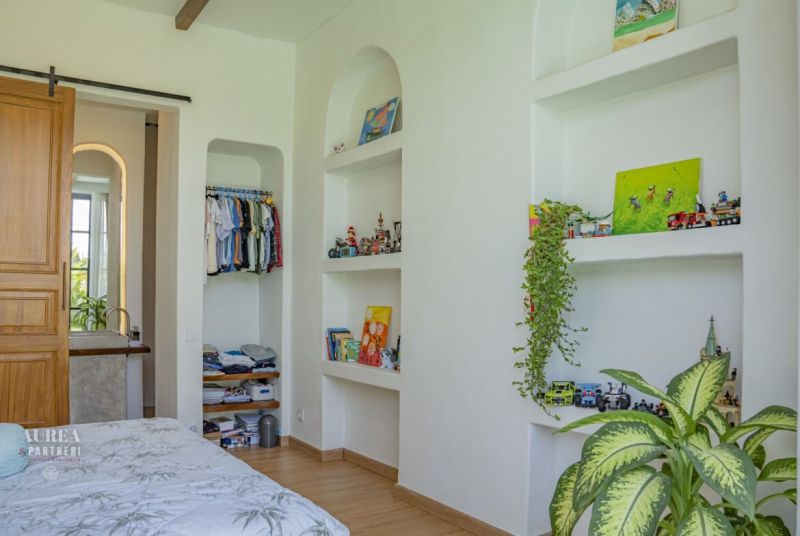The interior of the villa with built-in storage spaces and decorative items.