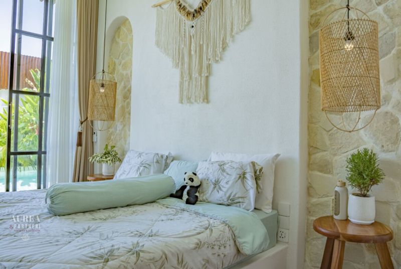 A room in a villa with a comfortable bed, decorations, and space for relaxation.