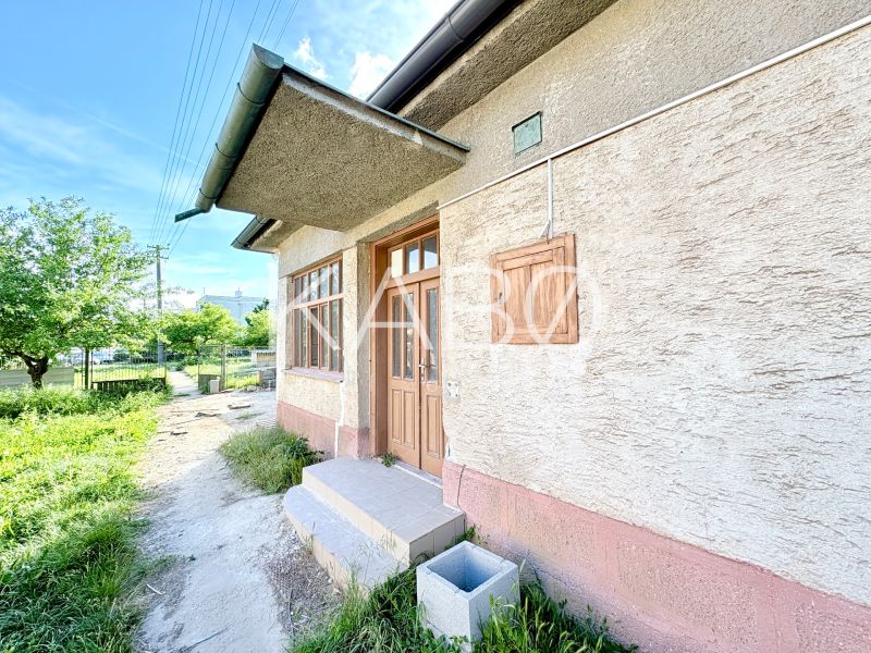 A family house in Šoporňa with an external entrance and a green front garden.