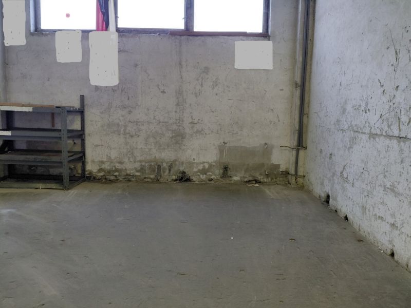 The space of a worn-out hall with a wall, a shelf, and a window in Warehouses and Halls.