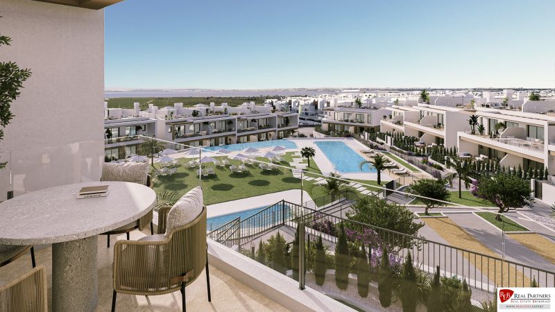 View from the balcony of a 2-bedroom apartment in Torrevieja, pool and outdoor loungers.