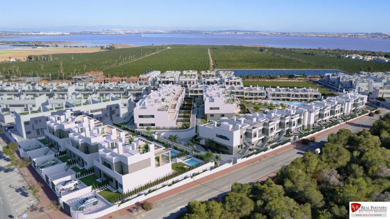 A view of a residential complex extending to the lagoon in Torrevieja, offering 2-bedroom apartments.