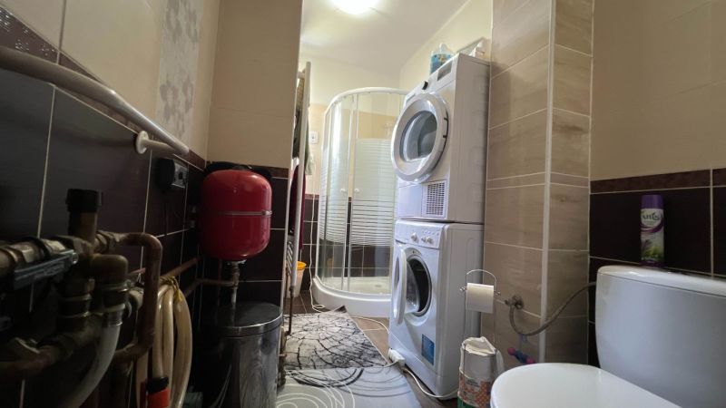 Bathroom in a 3-room apartment with a washing machine, shower, and installations.