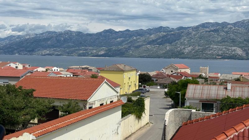 View of the coast and mountains in Ražanac from a family house with red roofs.