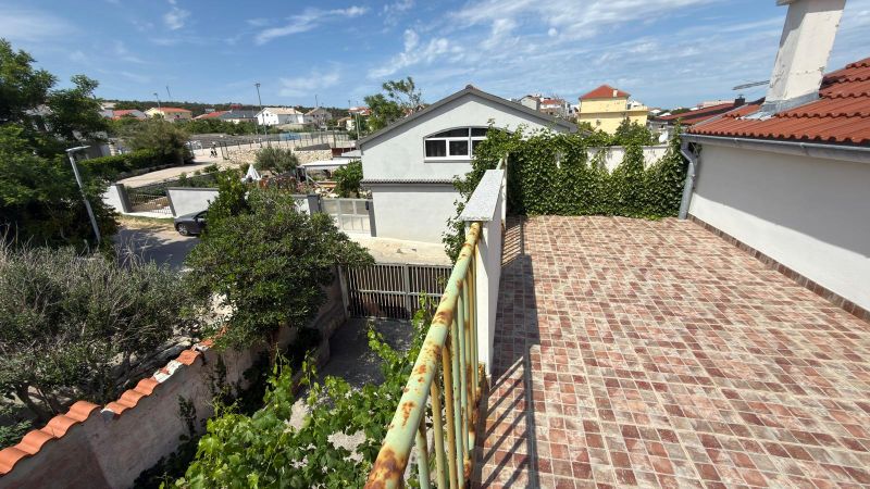 View from the terrace of a family house in Ražanac overlooking the roofs and greenery.