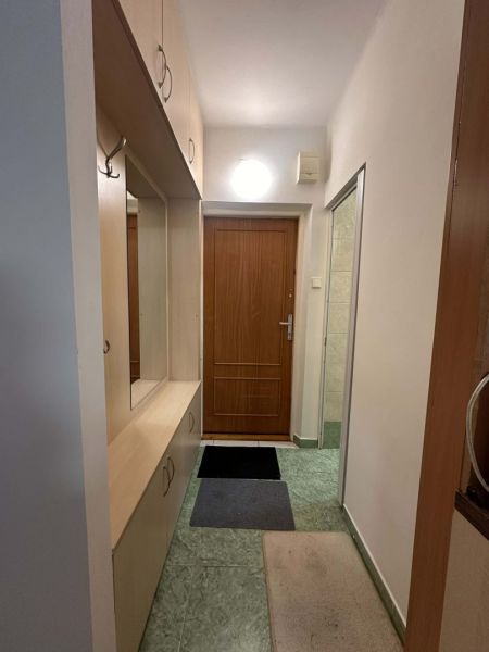 Entrance hallway in a holiday apartment with built-in wardrobes and coat racks.