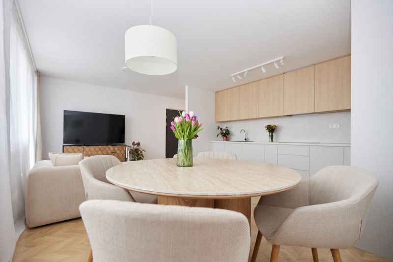 Dining table with chairs in a 4-room apartment, next to the kitchen.