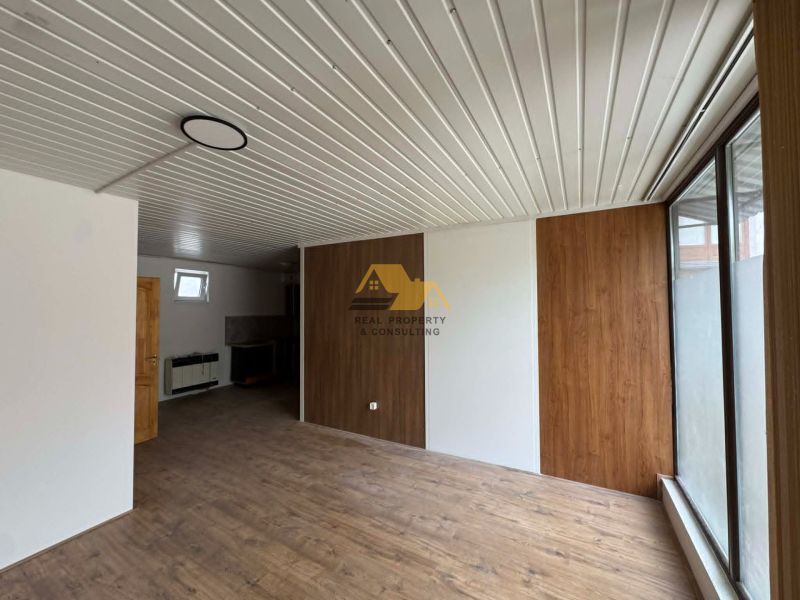 2-room apartment with wood-patterned flooring and wooden wall cladding.