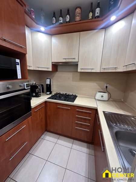 A kitchen with a corner unit and appliances in a 3-room apartment, ceramic tiles.
