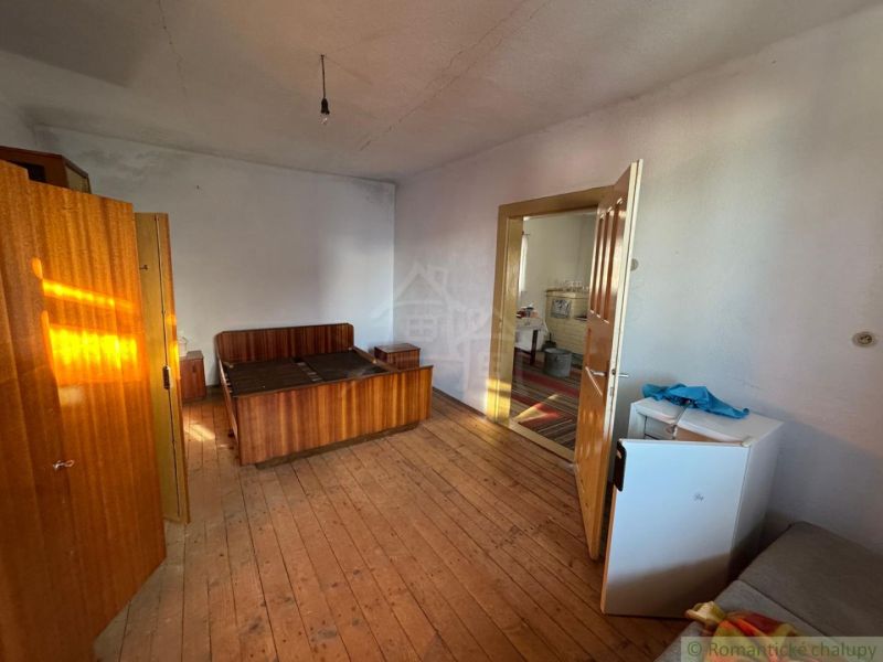 A bedroom in a family house with wooden floor decor, simple furnishings.