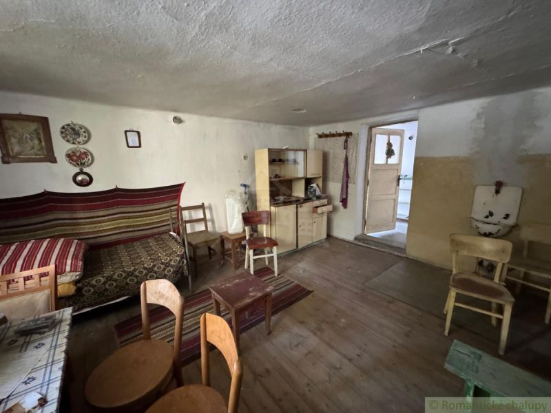 Interior of a family house with simple furniture and a wooden decor floor.