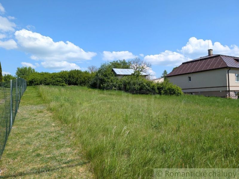 Grassy residential plots in Karna with a view of the house and blue sky.
