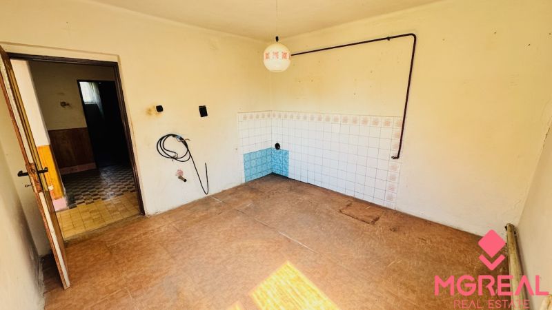 Interior of a family house with white walls and a floor with a wooden decor.