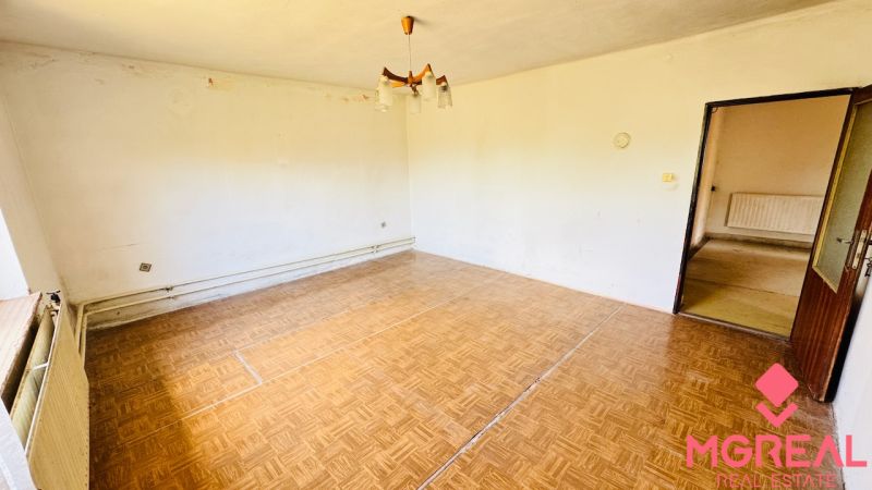 Living room in a family house with a wooden decor floor and simple lighting.