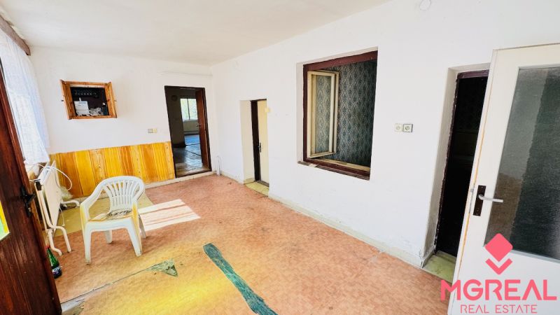 Interior of a family house with a plastic chair, doors, and an electrical box on the wall.