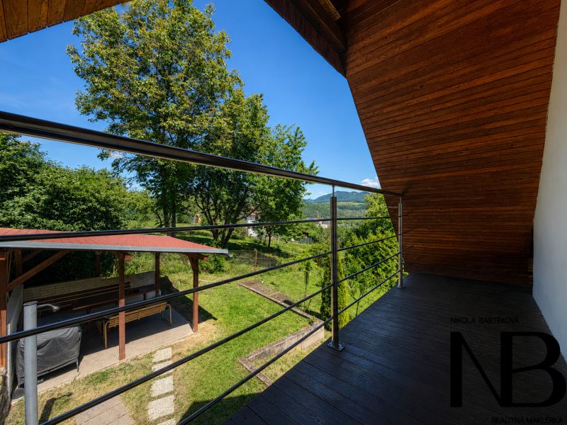 The balcony of the cottage with a view of greenery and a gazebo on Klučina Street, Považská Bystrica.