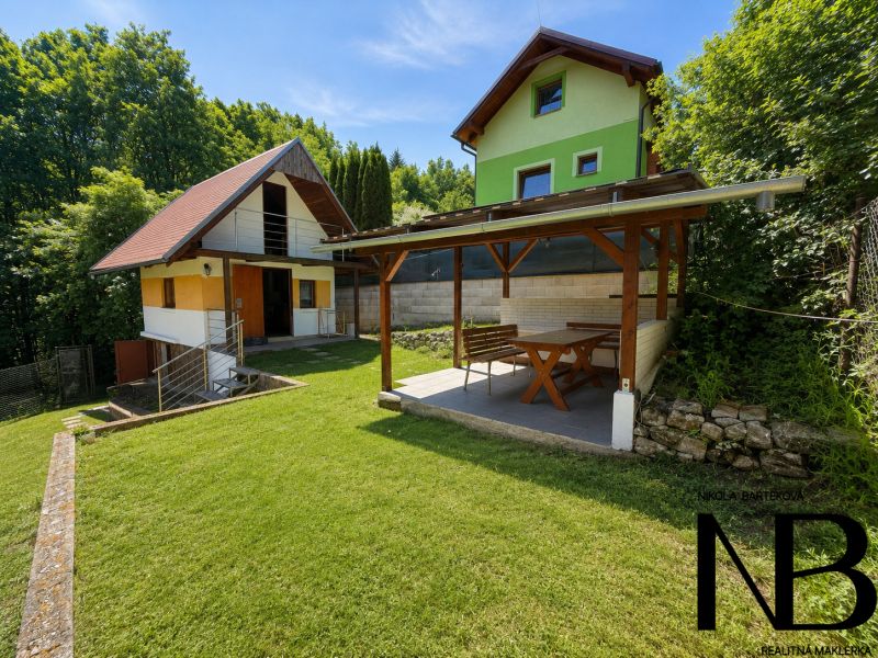 A cottage on Klučina in Považská Bystrica with a gazebo and lawn, surrounded by greenery.