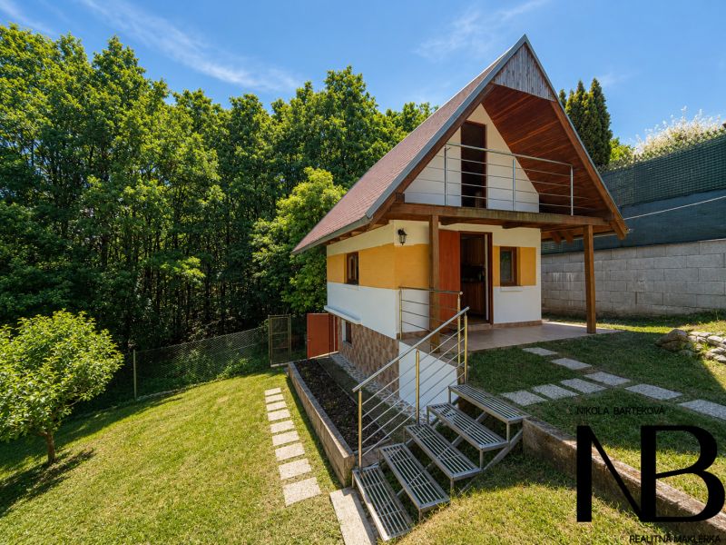 A cottage with wooden decor in Považská Bystrica at Klučina, surrounded by greenery and trees.