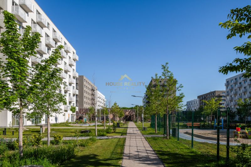 Modern apartment buildings with greenery on Ivanská cesta in Bratislava, Ružinov area.
