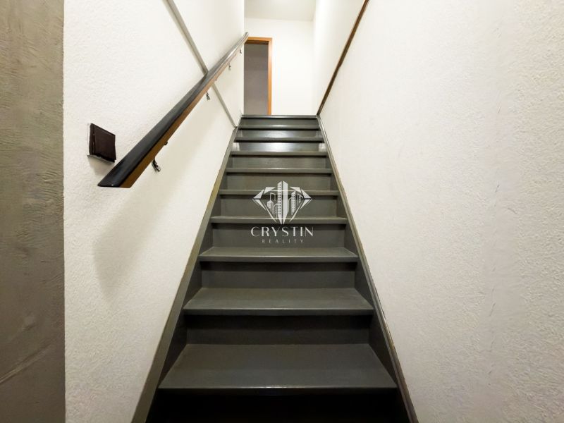 A staircase with a black railing in a family house.