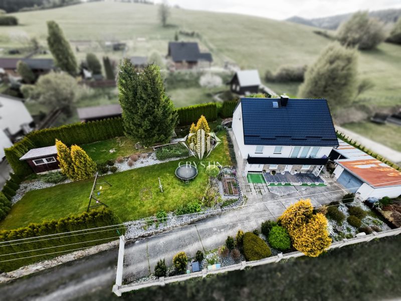 A family house in Makov with a spacious garden and trees, from a bird's-eye view.