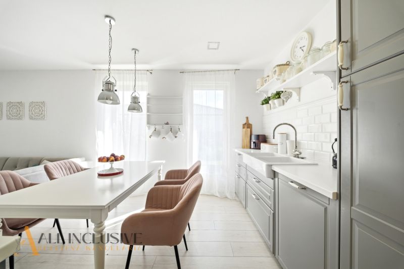 A bright kitchen in a family house with an elegant interior and a wooden decor floor.
